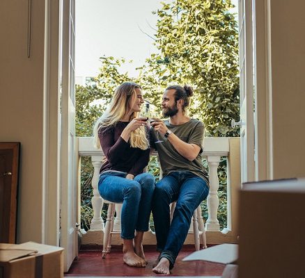 Couple Sitting In Balcony Toasting Their Glasses On Wine